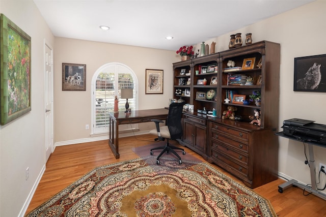 office area featuring baseboards, light wood finished floors, and recessed lighting
