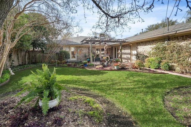 view of yard with a pergola and fence