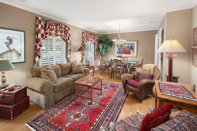 living area with crown molding, a chandelier, and wood finished floors