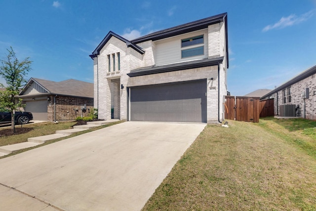 traditional home featuring a garage, a front lawn, central AC unit, brick siding, and driveway