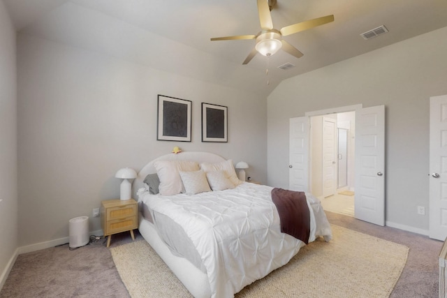 bedroom with visible vents, light colored carpet, and vaulted ceiling