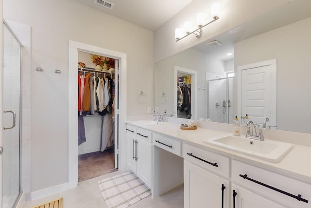 3238 Baehr Dr, Royse City, TX 75189 - bathroom with a walk in closet, double vanity, a stall shower, and tile patterned flooring