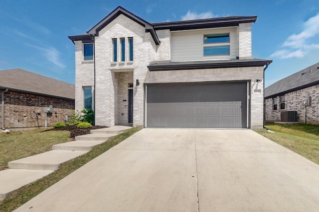 view of front of home with central air condition unit, an attached garage, and driveway