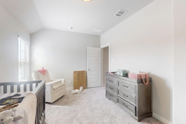 bedroom with light colored carpet, visible vents, baseboards, and lofted ceiling