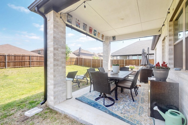 view of patio with a fenced backyard and outdoor dining area
