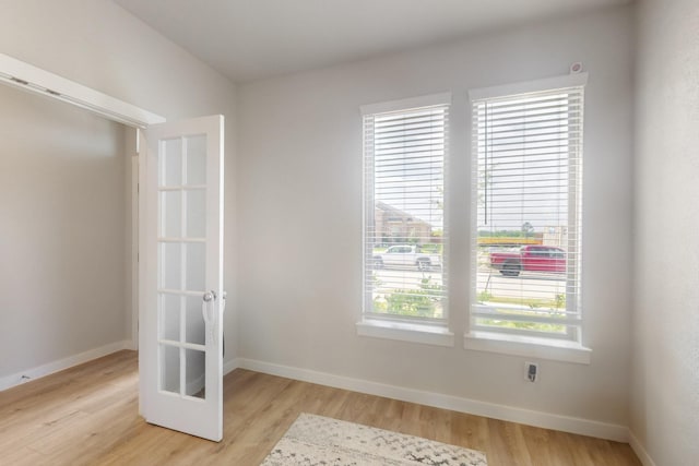 empty room with light wood-style flooring and baseboards