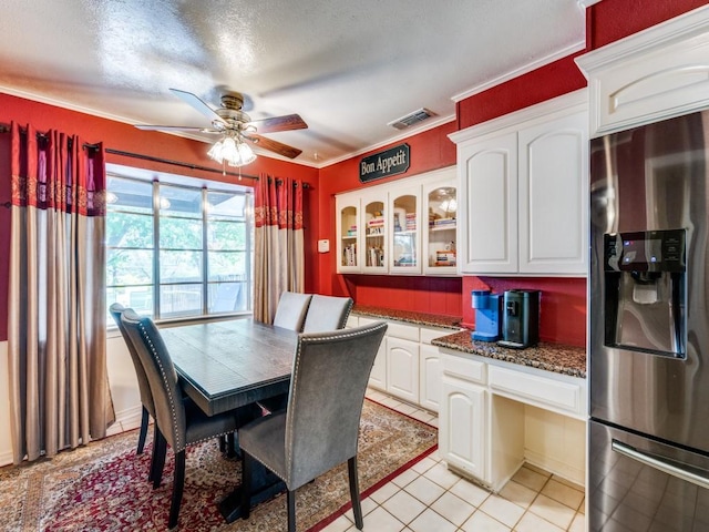 dining area with a ceiling fan, crown molding, visible vents, and light tile patterned floors