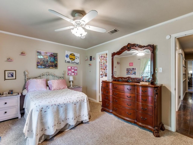 bedroom with light colored carpet, ornamental molding, and visible vents