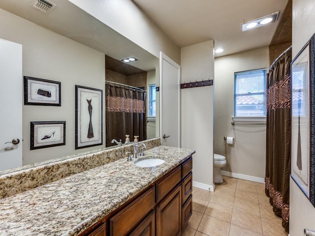 bathroom featuring vanity, baseboards, toilet, tile patterned flooring, and visible vents
