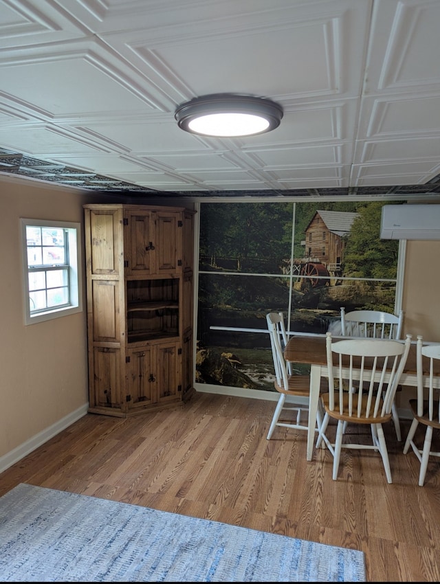 dining area featuring baseboards, an ornate ceiling, and light wood-style floors