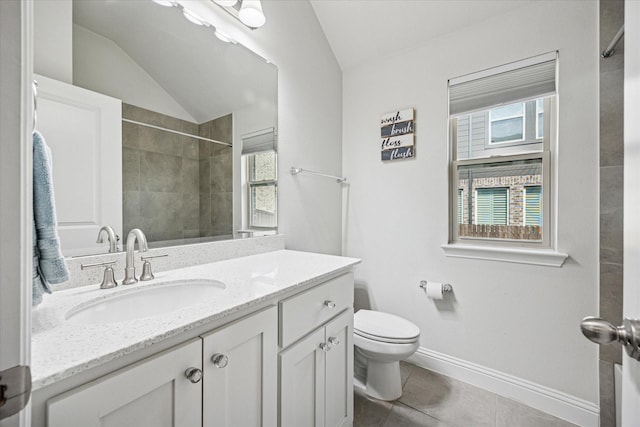 511 Ranchwood Dr, Justin, TX 76247 - bathroom featuring toilet, vanity, vaulted ceiling, tile patterned flooring, and a tile shower