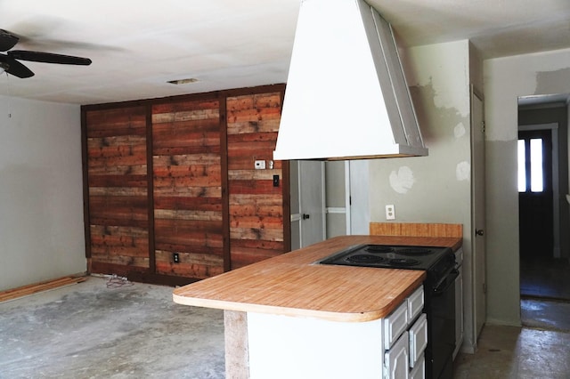 kitchen featuring unfinished concrete flooring, a ceiling fan, black electric range, and extractor fan