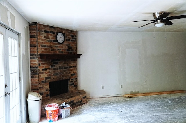 unfurnished living room featuring a brick fireplace and ceiling fan