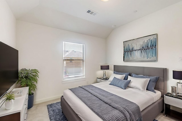 bedroom with light colored carpet, lofted ceiling, visible vents, and baseboards
