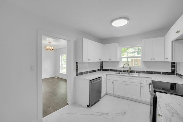 2126 Cedar St, Paris, TX 75460 - kitchen featuring white cabinets, a sink, tasteful backsplash, a chandelier, and appliances with stainless steel finishes