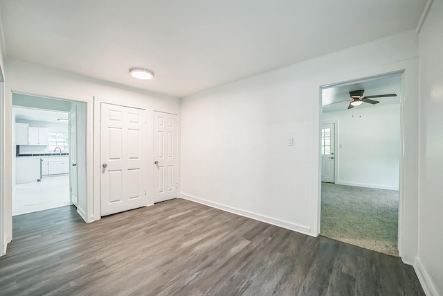 2126 Cedar St, Paris, TX 75460 - unfurnished room featuring a ceiling fan, baseboards, dark wood-style flooring, and a sink