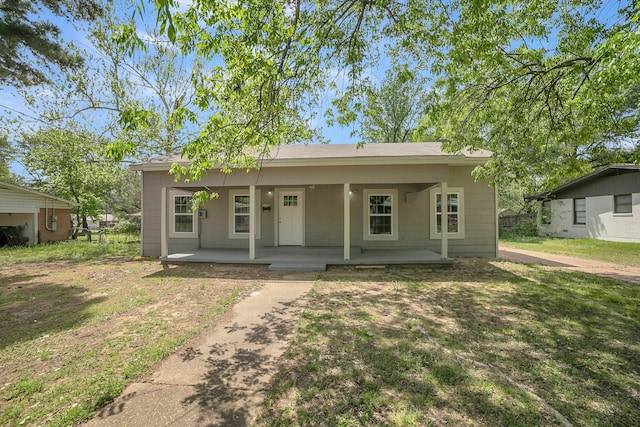 2126 Cedar St, Paris, TX 75460 - bungalow featuring a front yard and covered porch