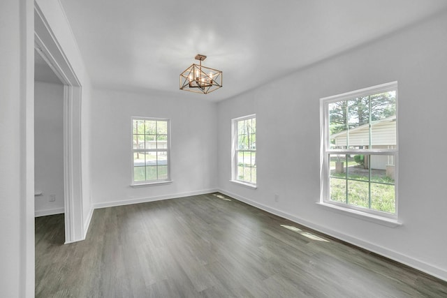 2126 Cedar St, Paris, TX 75460 - unfurnished room featuring dark wood-style flooring, a notable chandelier, and baseboards