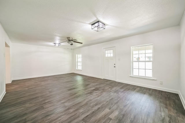 2126 Cedar St, Paris, TX 75460 - entryway with baseboards, a textured ceiling, a ceiling fan, and dark wood-style floors