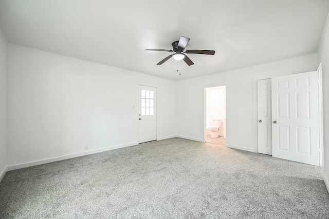 2126 Cedar St, Paris, TX 75460 - unfurnished bedroom with ceiling fan, carpet flooring, baseboards, and ensuite bathroom
