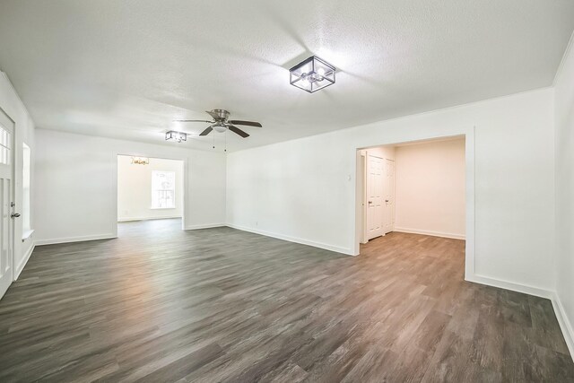 2126 Cedar St, Paris, TX 75460 - empty room with dark wood finished floors, ceiling fan, baseboards, and a textured ceiling