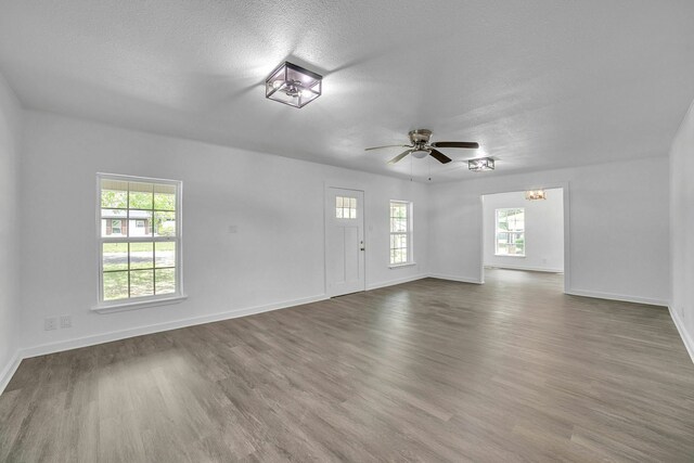 2126 Cedar St, Paris, TX 75460 - interior space featuring baseboards, a ceiling fan, wood finished floors, and a textured ceiling