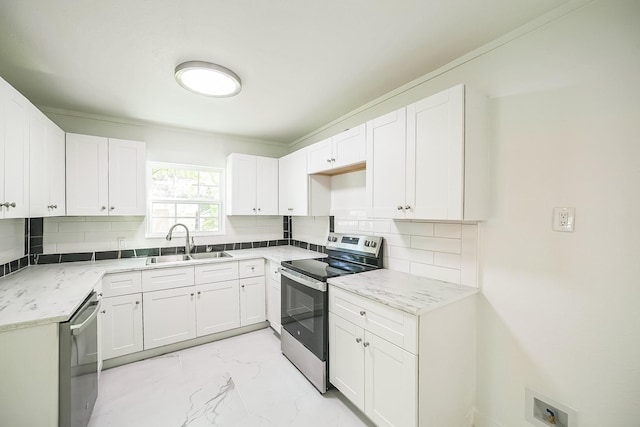 2126 Cedar St, Paris, TX 75460 - kitchen featuring a sink, white cabinetry, backsplash, marble finish floor, and appliances with stainless steel finishes