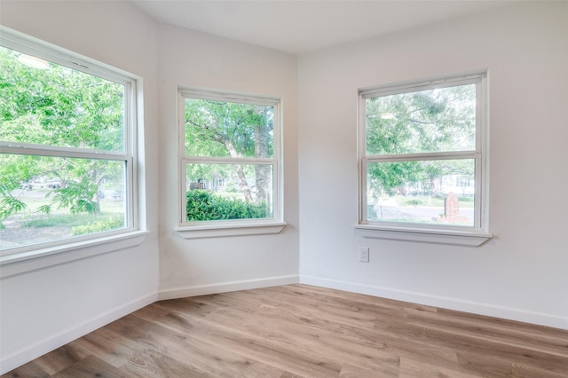 604 N E St, Arlington, TX 76011 - spare room with plenty of natural light, baseboards, and wood finished floors