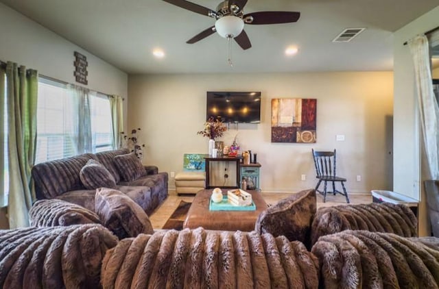 living area with recessed lighting, visible vents, a ceiling fan, and baseboards
