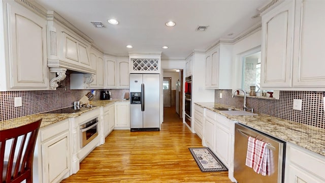 1351 Porter Ct, Granbury, TX 76048 - kitchen with light wood-style flooring, visible vents, a sink, and appliances with stainless steel finishes