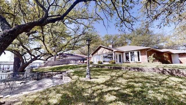 1351 Porter Ct, Granbury, TX 76048 - exterior space featuring fence, a lawn, a chimney, and brick siding