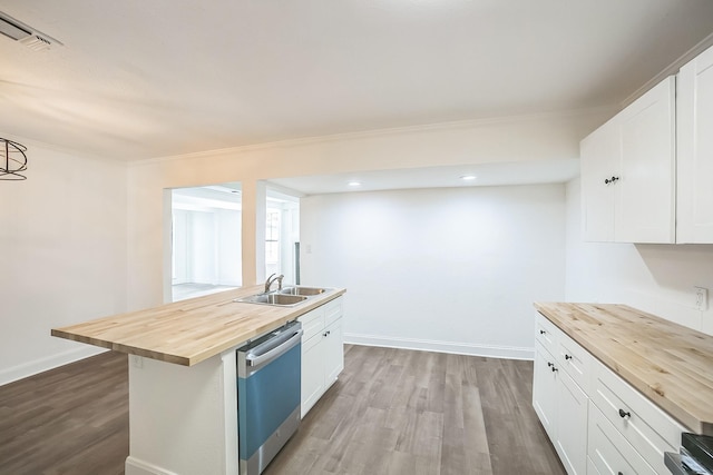 kitchen featuring wood counters, wood finished floors, a sink, and dishwashing machine