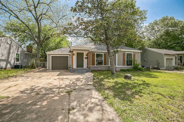 view of front of home with concrete driveway, a front lawn, an attached garage, cooling unit, and roof with shingles