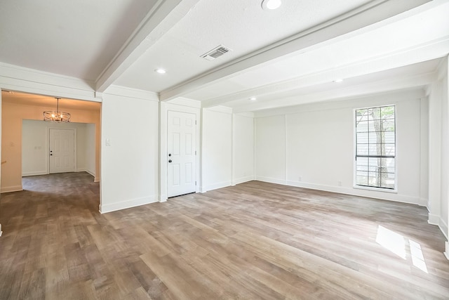 unfurnished room with light wood-style floors, beamed ceiling, baseboards, a notable chandelier, and visible vents