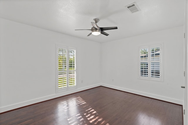 1413 S Waverly Dr, Dallas, TX 75208 - empty room with dark wood-style floors, a ceiling fan, visible vents, and plenty of natural light
