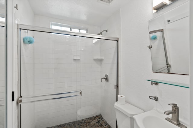 1413 S Waverly Dr, Dallas, TX 75208 - bathroom with toilet, a sink, visible vents, and a stall shower