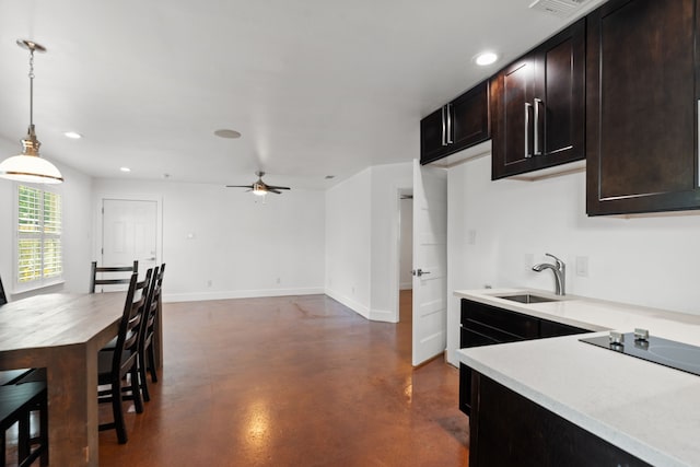 1413 S Waverly Dr, Dallas, TX 75208 - kitchen with black electric cooktop, light countertops, a sink, decorative light fixtures, and finished concrete floors