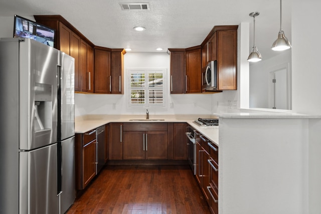 1413 S Waverly Dr, Dallas, TX 75208 - kitchen with a sink, stainless steel appliances, light countertops, dark wood-type flooring, and visible vents