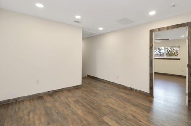 empty room with baseboards, wood finished floors, visible vents, and recessed lighting