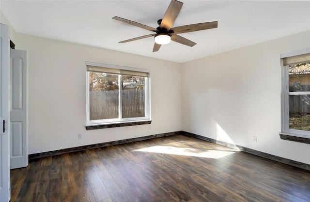 empty room featuring wood finished floors, a ceiling fan, and baseboards