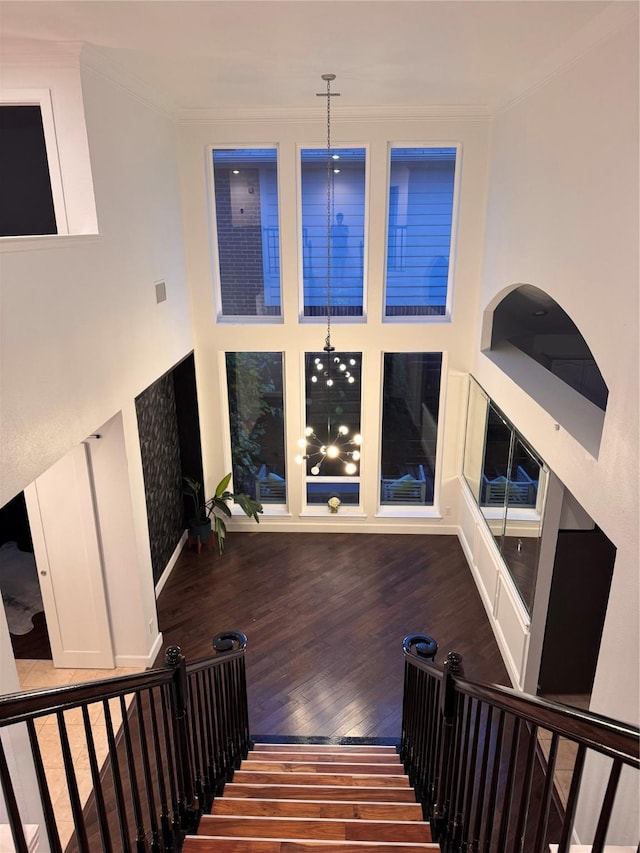 18815 Park Grove Ln, Dallas, TX 75287 - stairway with wood finished floors, crown molding, and a high ceiling