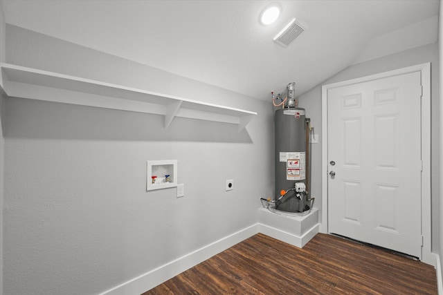 laundry room featuring hookup for an electric dryer, visible vents, water heater, dark wood-style flooring, and laundry area