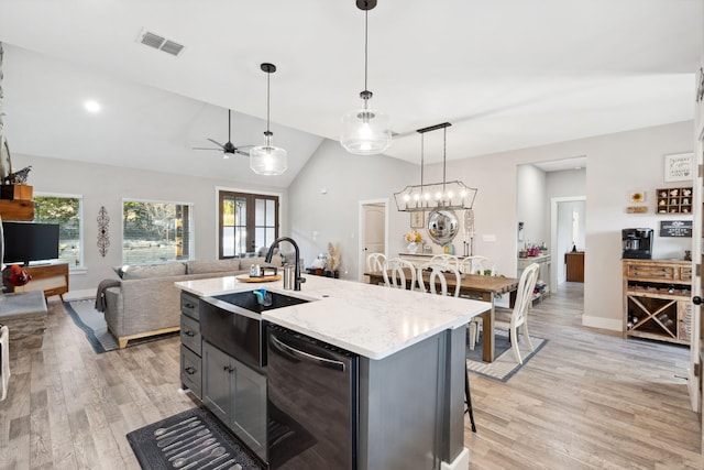 kitchen with light wood finished floors, a ceiling fan, visible vents, and a sink