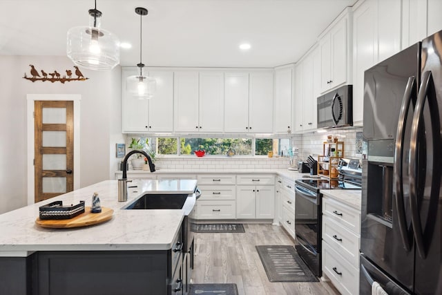 kitchen featuring a sink, range with electric cooktop, backsplash, light wood-style floors, and black fridge with ice dispenser
