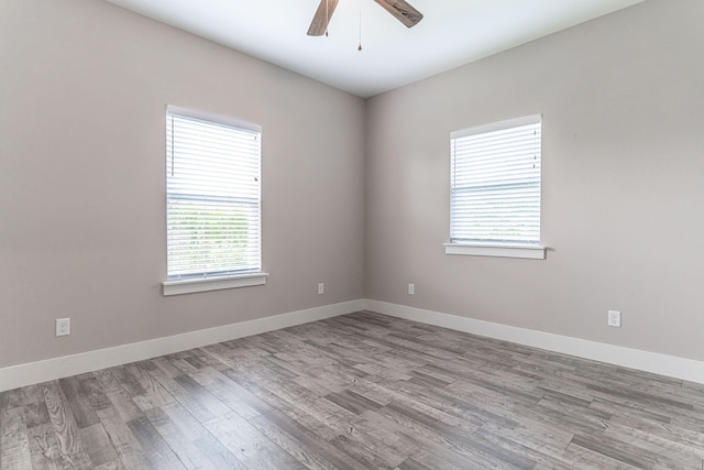 unfurnished room featuring baseboards, a ceiling fan, and wood finished floors