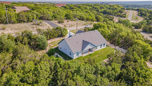 drone / aerial view with a wooded view