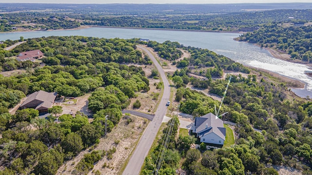bird's eye view featuring a forest view and a water view