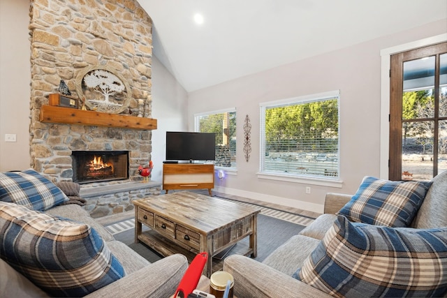 living room with baseboards, wood finished floors, a fireplace, and high vaulted ceiling