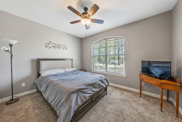 bedroom with ceiling fan, baseboards, and carpet