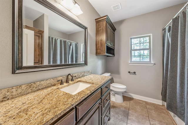 bathroom featuring tile patterned floors, visible vents, toilet, vanity, and baseboards
